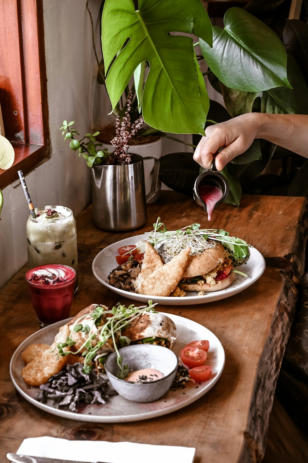 two plates of food on a wooden table