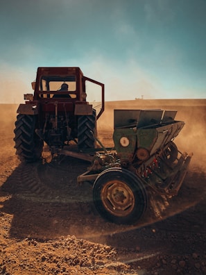 a tractor is plowing a field with dirt
