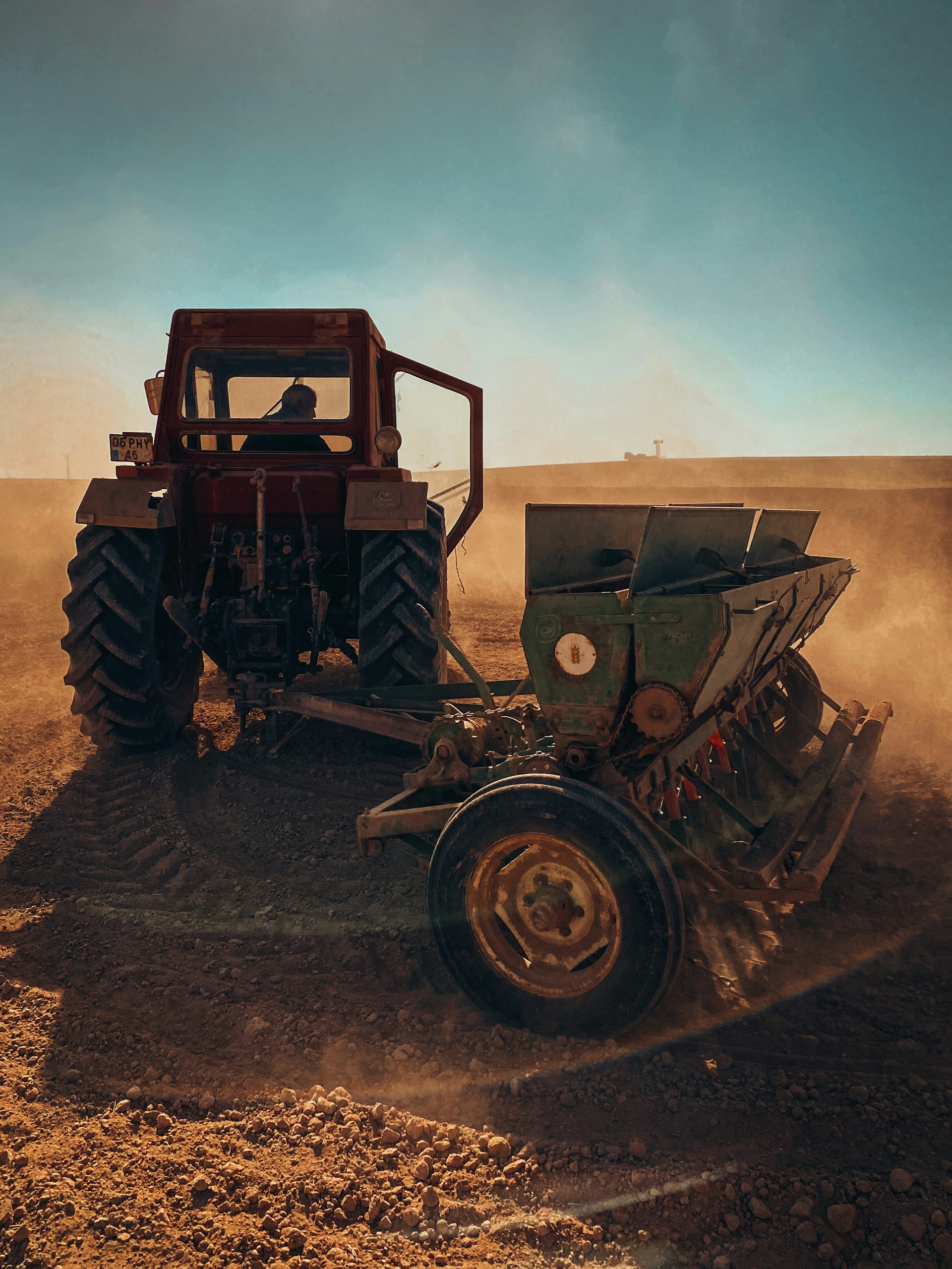 a tractor is plowing a field with dirt
