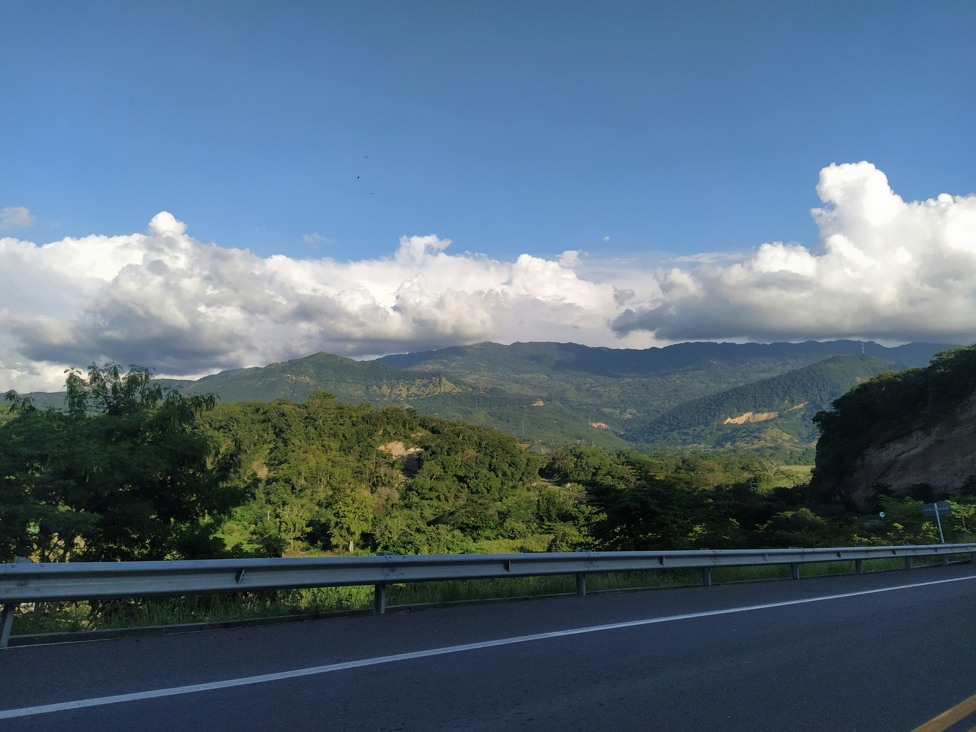 a scenic view of a mountain range from a highway