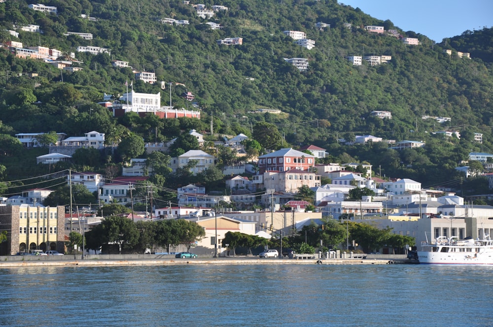 a view of a town on a hill with a boat in the water