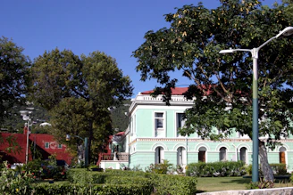 A sunlit historic building surrounded by oak trees in Conejo Valley.