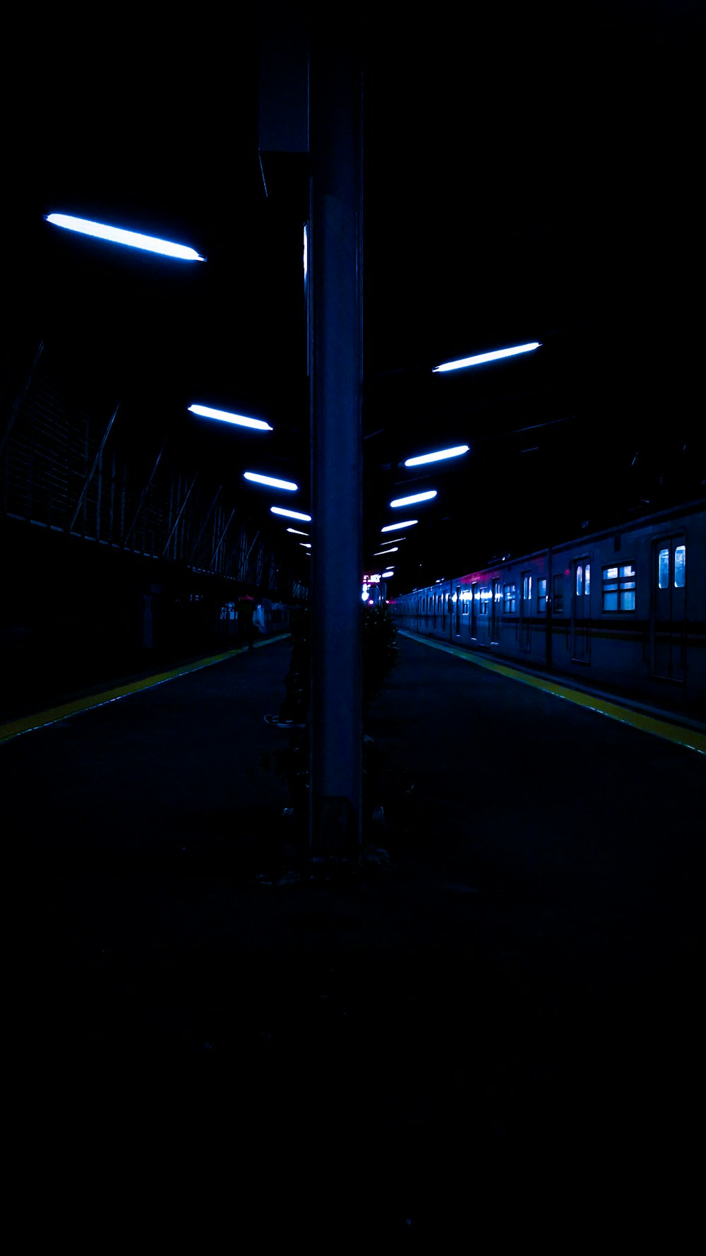 a train traveling down train tracks at night