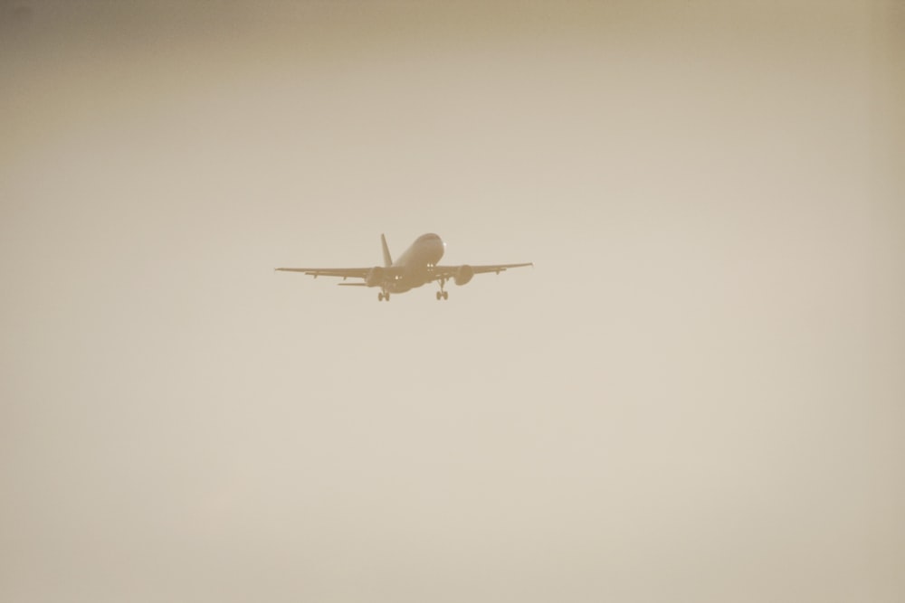 an airplane is flying through the foggy sky