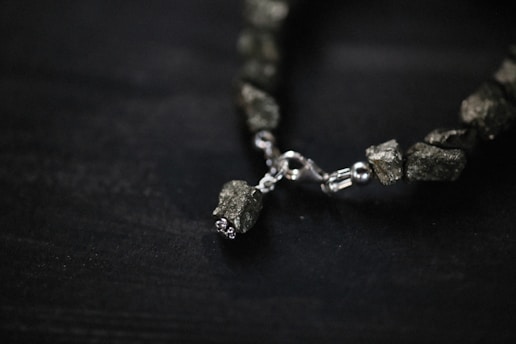 Close-up of artisanal jewelry pieces made from recycled metals and natural stones.