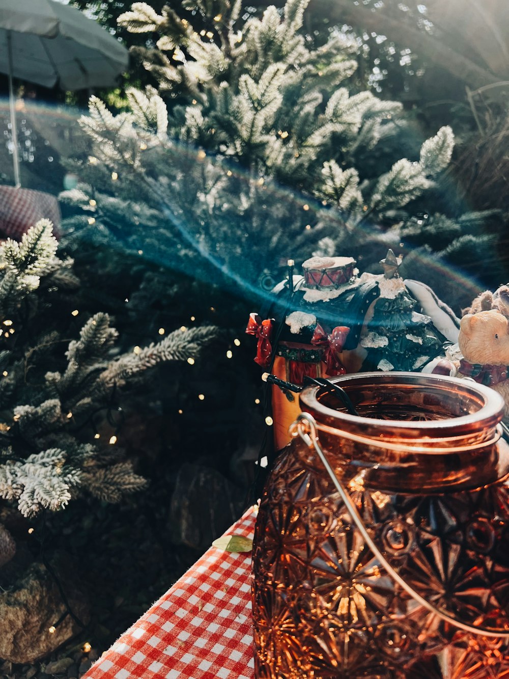 a teddy bear sitting on top of a table next to a jar