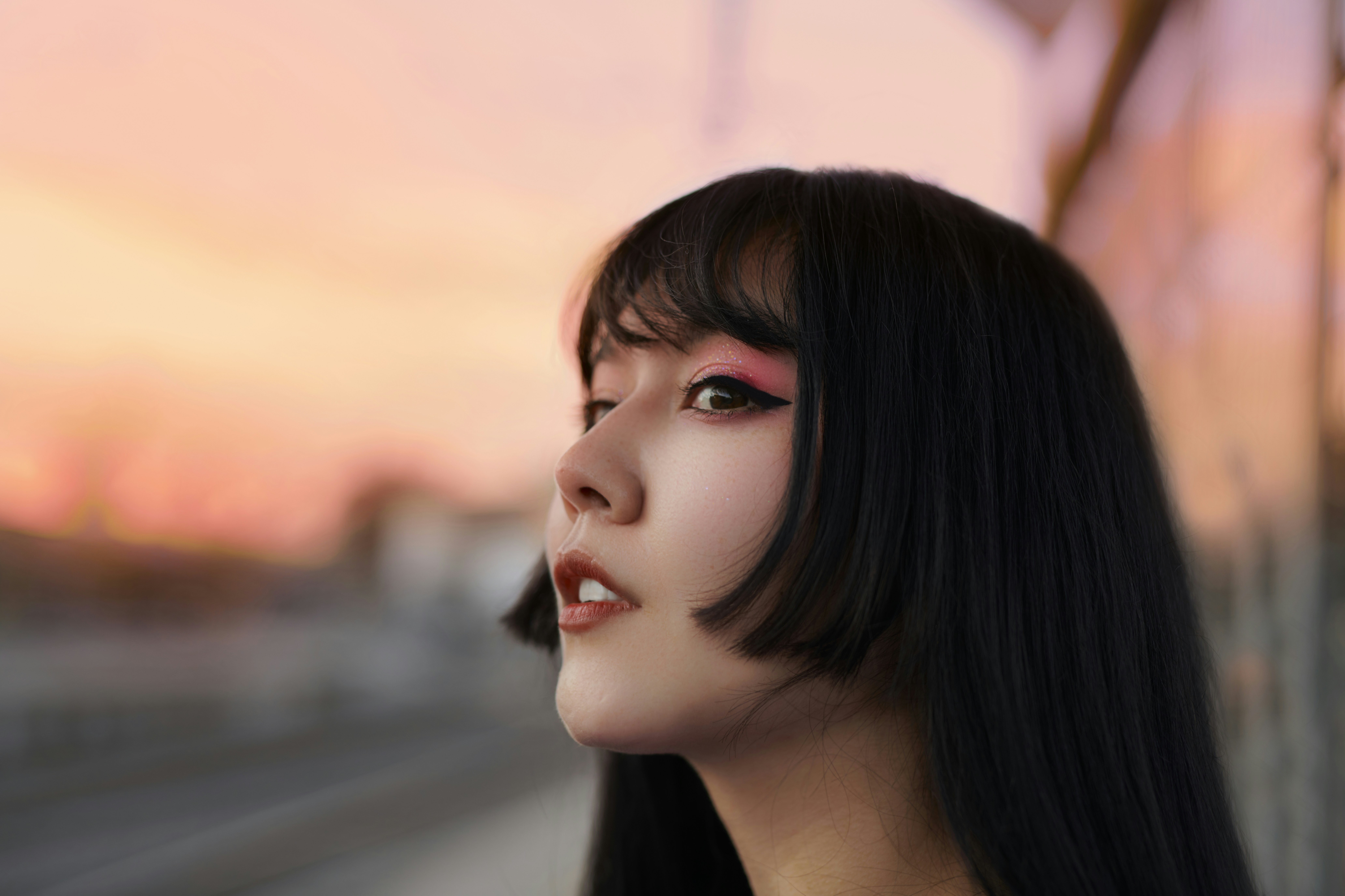 a woman with long black hair and makeup