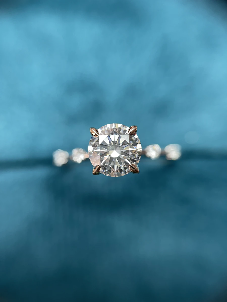 Diamond solitaire engagement ring on blue velvet