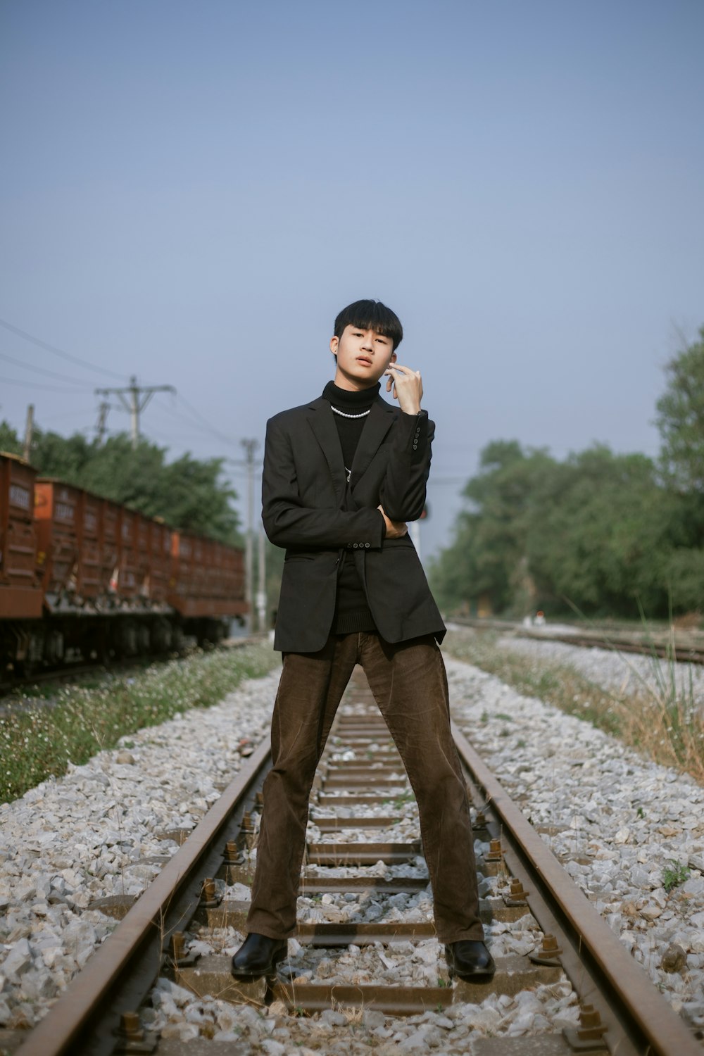 a man standing on a train track next to a train