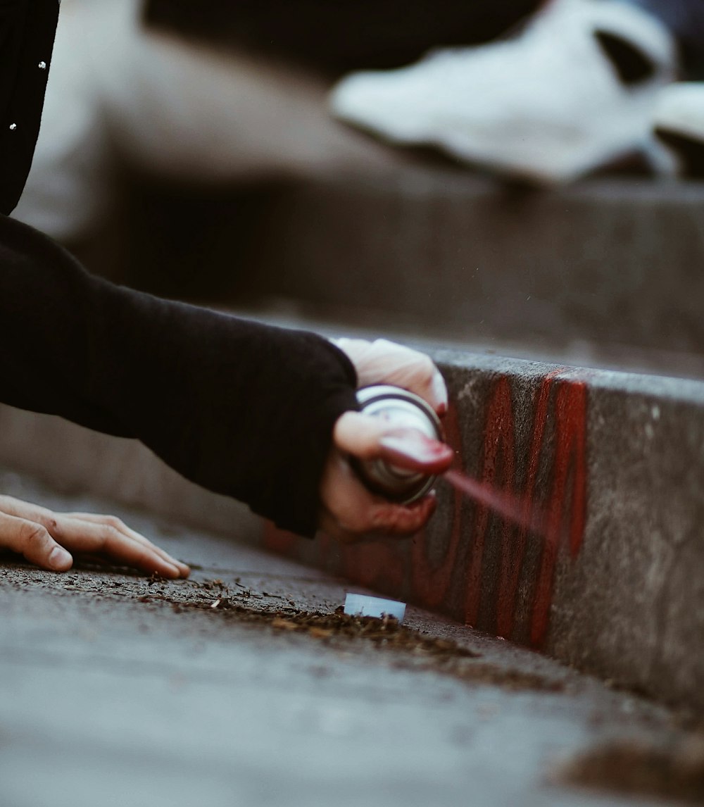 a person reaching for something on the ground