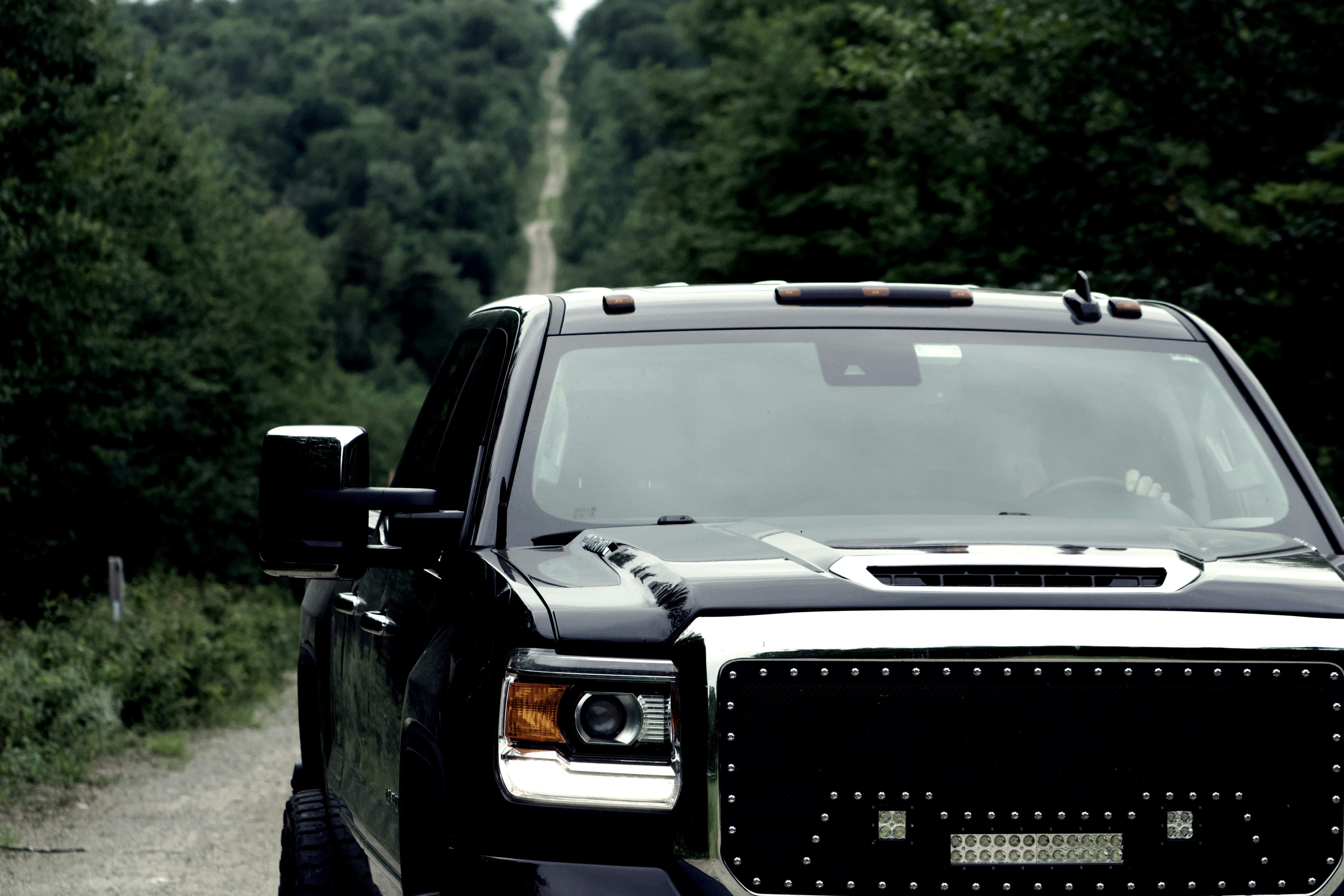 a black and white truck parked on a dirt road