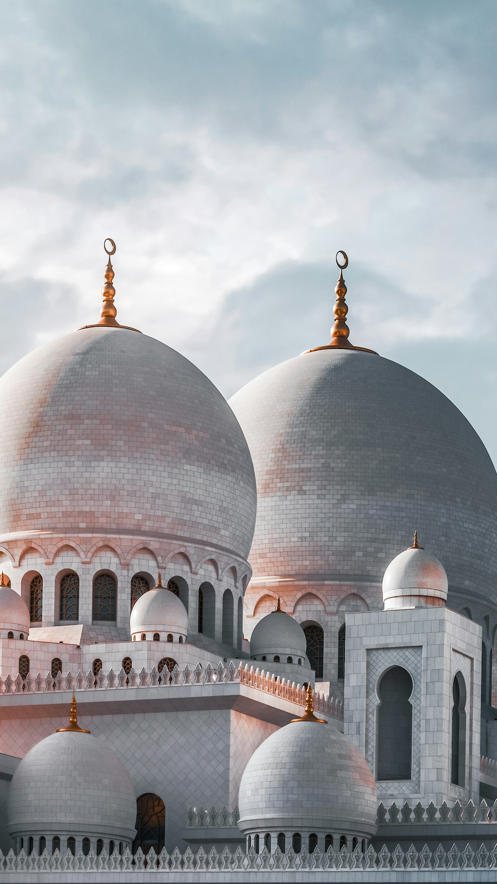 a large white building with two domes on top of it