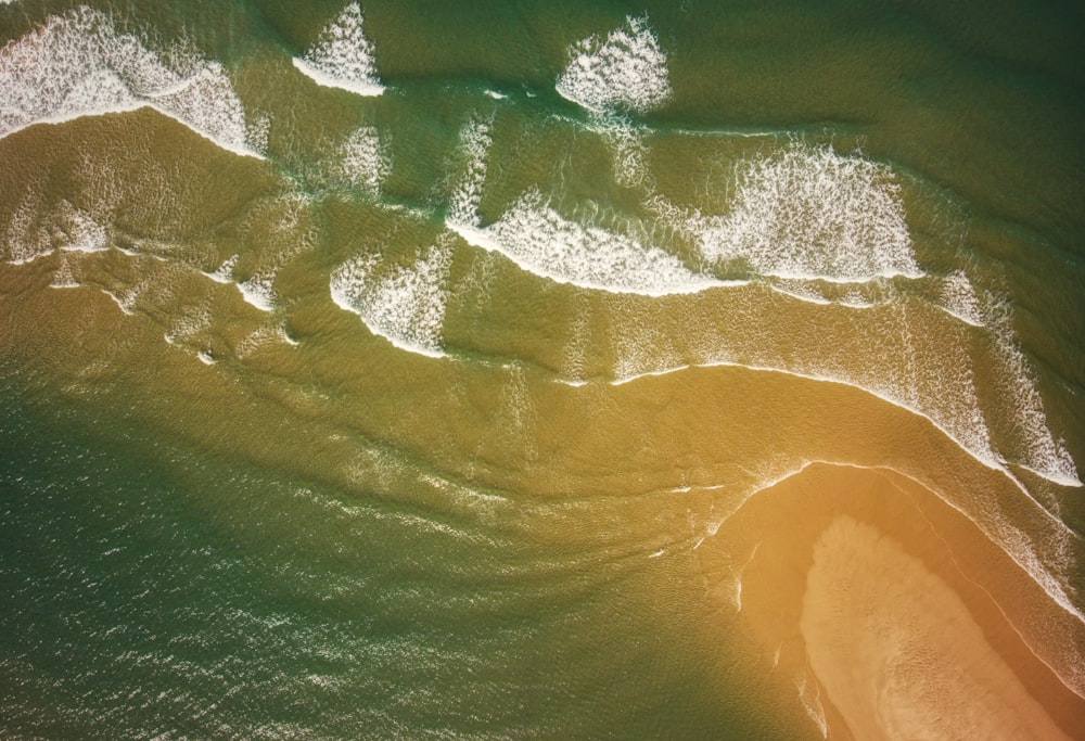 an aerial view of a sandy beach and ocean