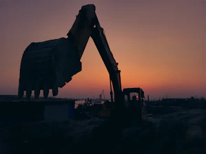 Elegant construction machinery silhouette against a subtle, contemporary background.