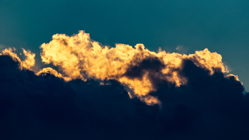 a plane flying in the sky with a lot of clouds