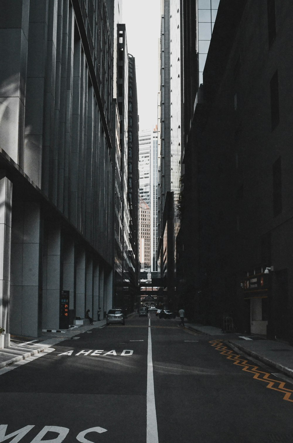 an empty city street with tall buildings in the background