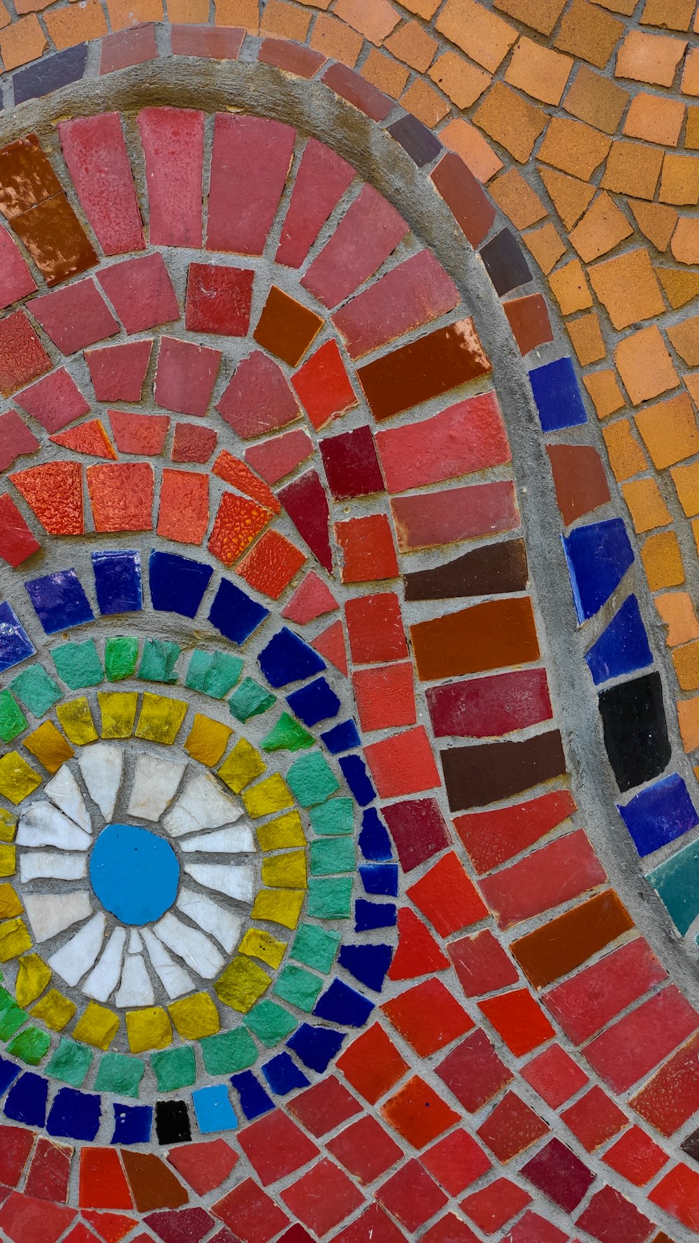 a close up of a colorful mosaic design on a wall