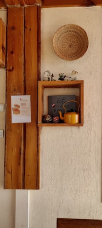 a wooden shelf with a basket on top of it