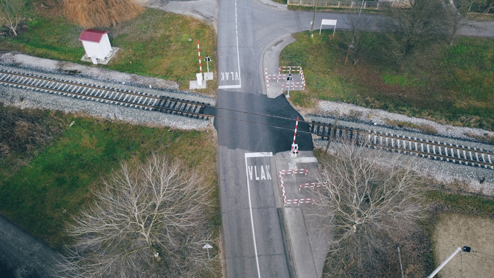 an aerial view of a road and railroad tracks