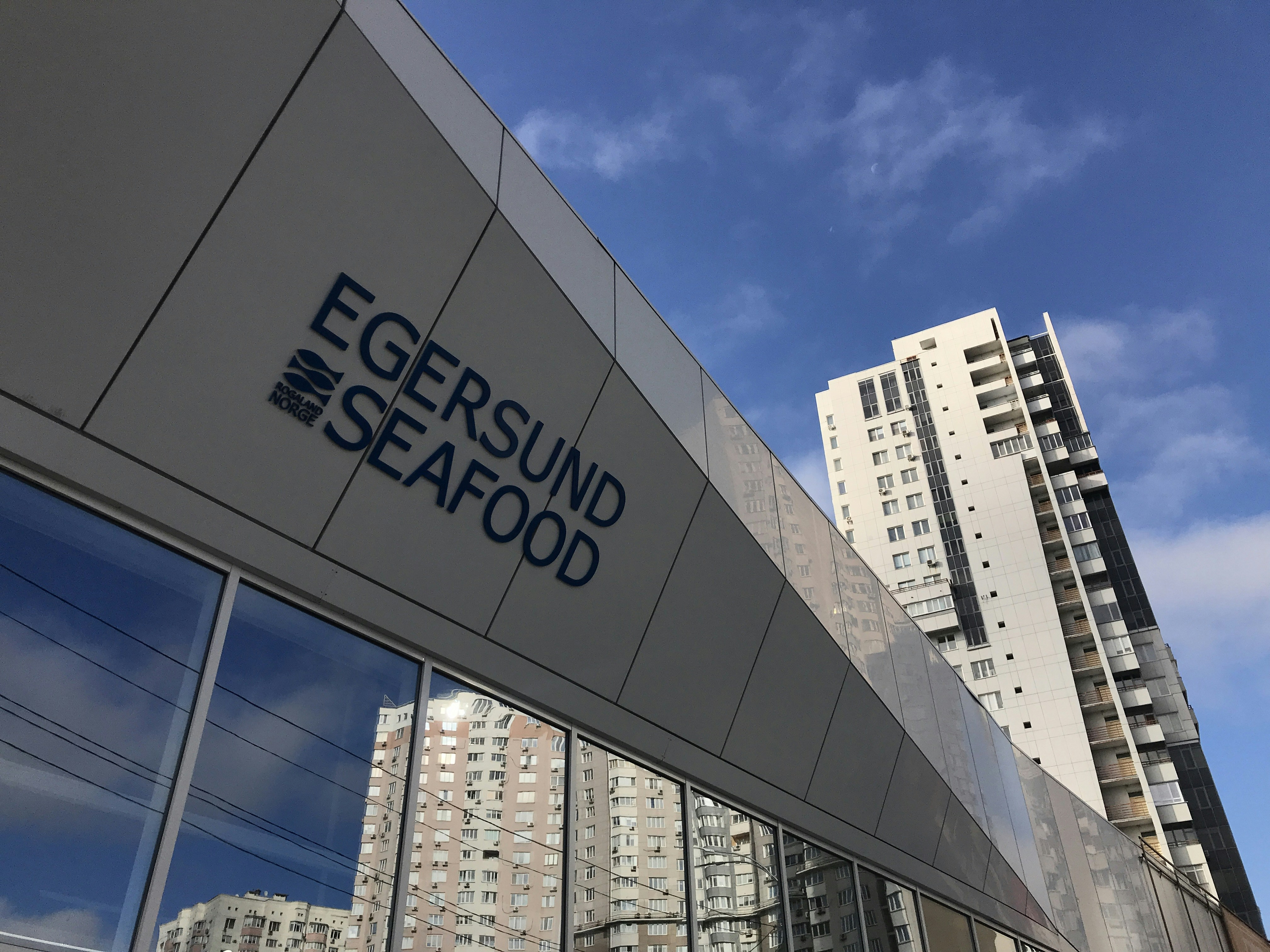 the edge of a building with windows and a sky background