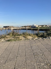 A welcoming view of Fairfield Harbour community by the water with residents walking and chatting.