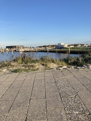 A welcoming view of Fairfield Harbour community by the water with residents walking and chatting.