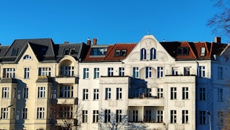 a large white building with a clock on the front of it
