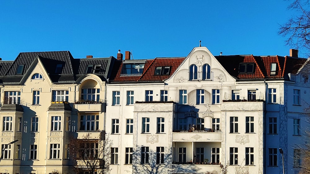 a large white building with a clock on the front of it