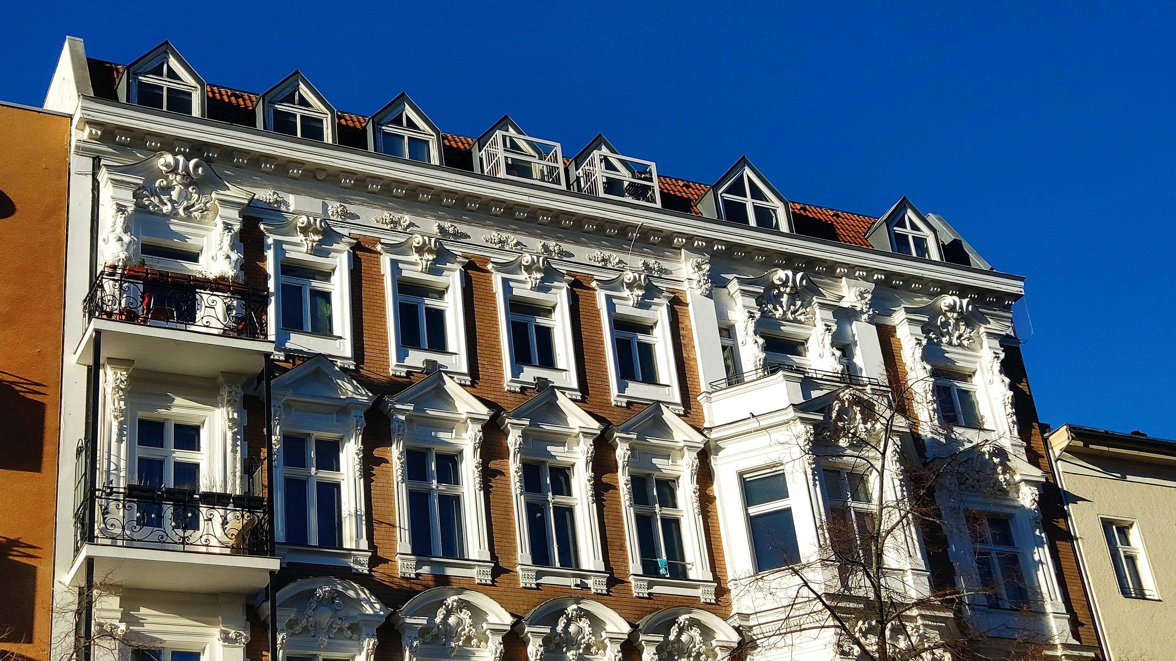 a tall building with many windows and balconies