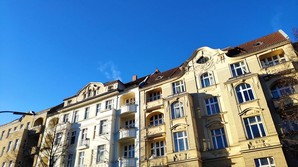 a row of multi - story buildings on a sunny day