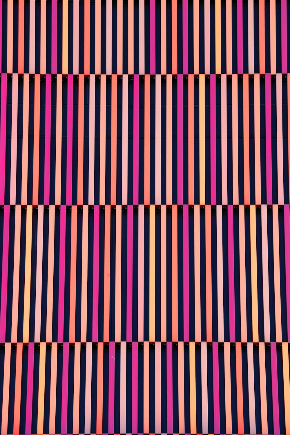 a multicolored striped wallpaper with vertical stripes