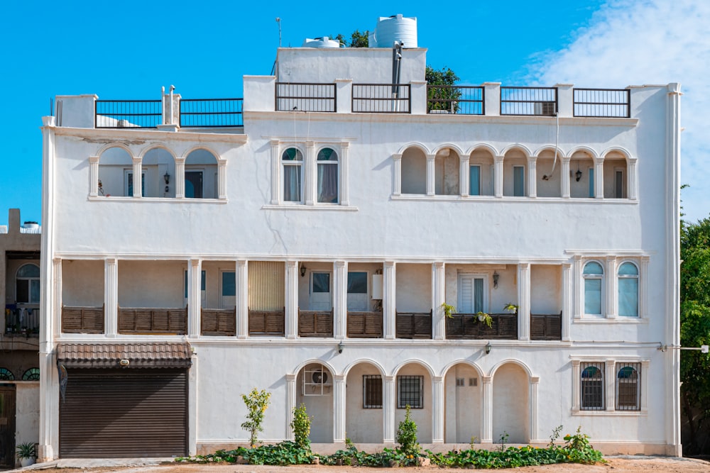 a large white building with lots of windows and balconies