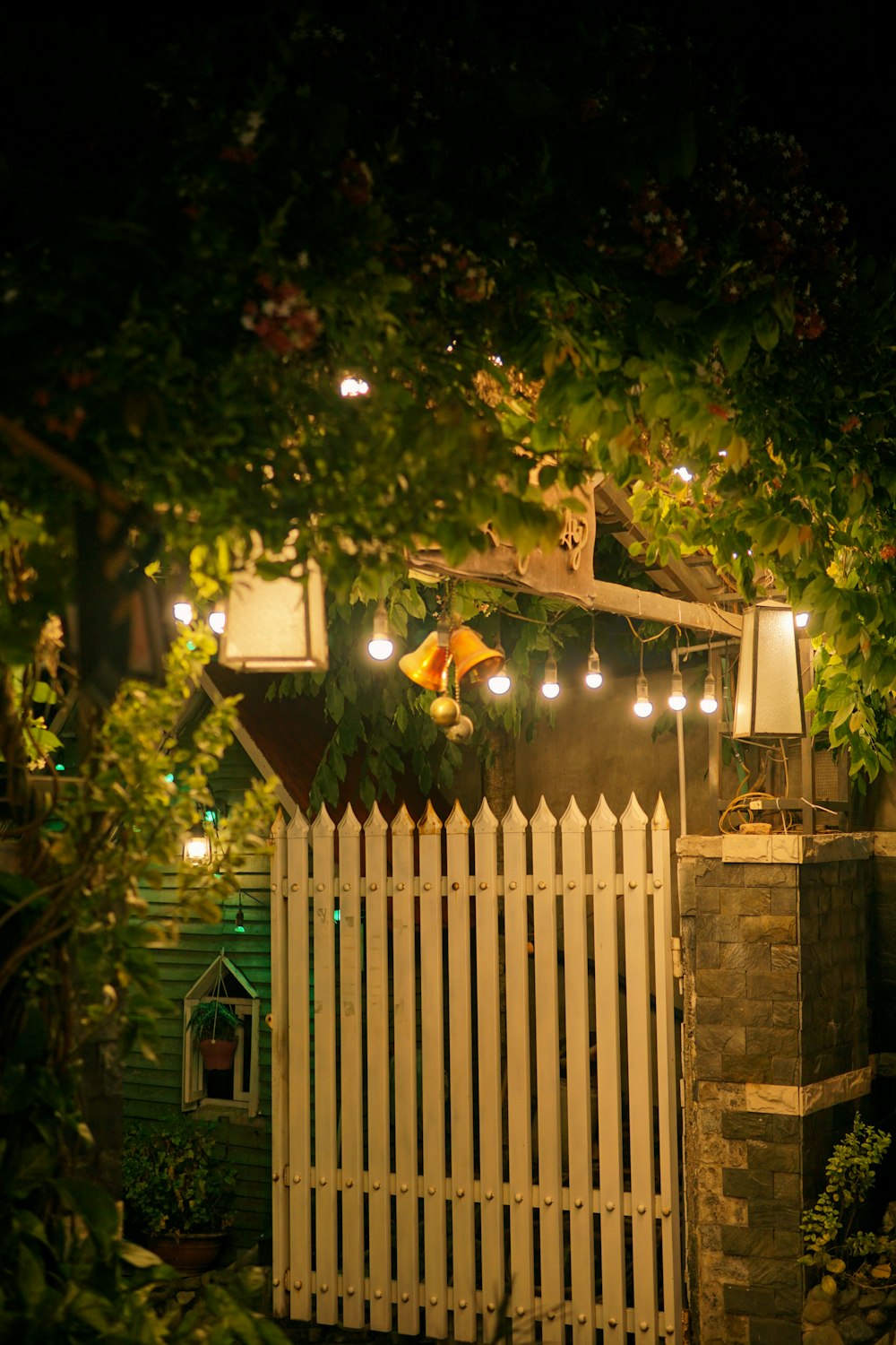 a white picket fence with some lights on it