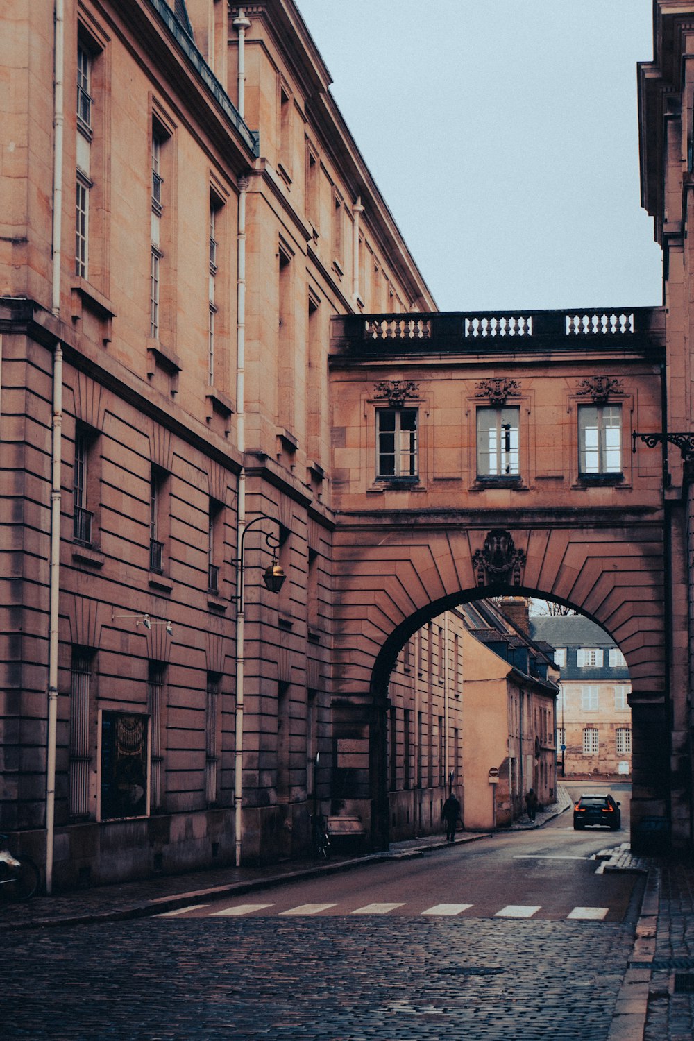 an arch in the middle of an old city street