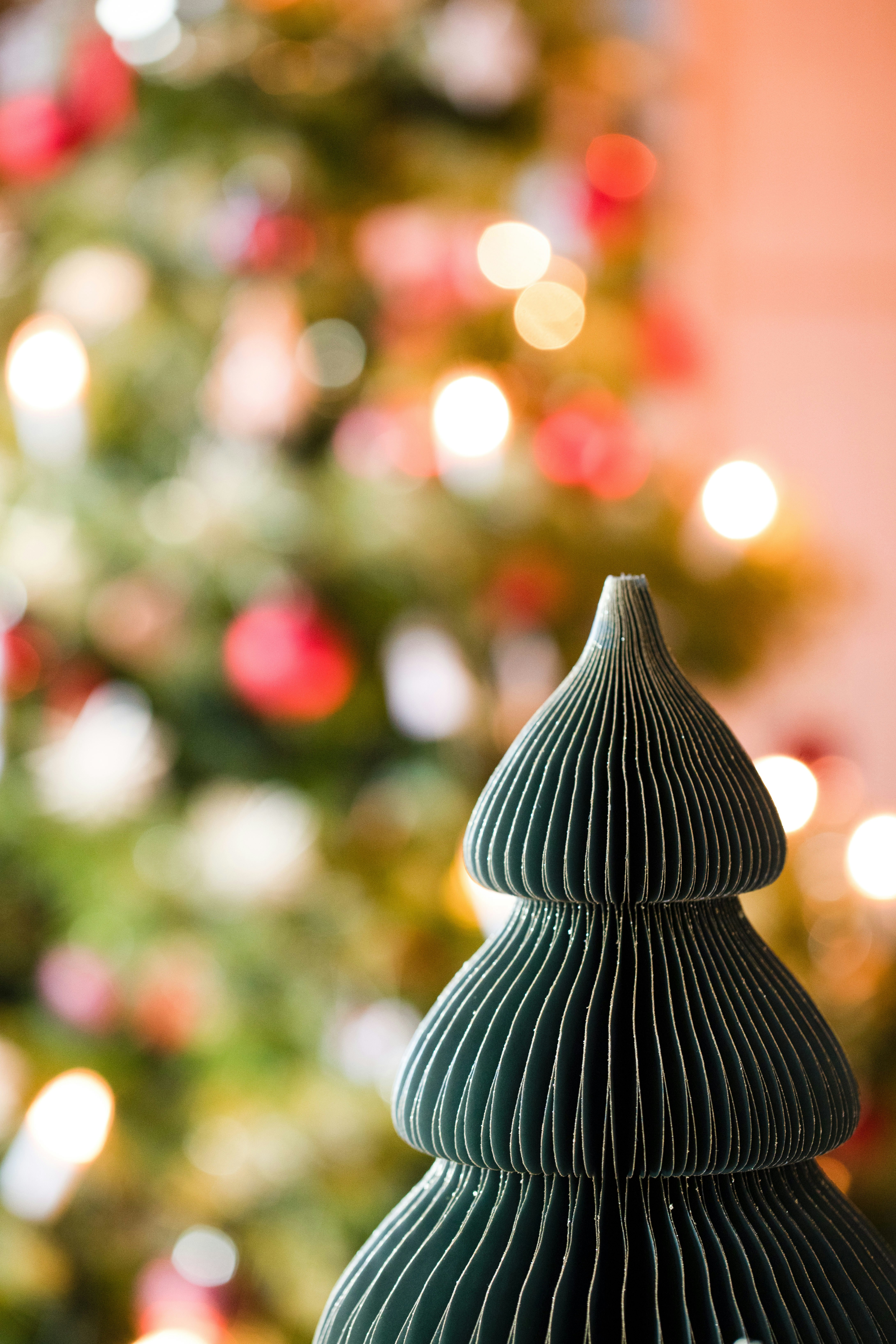 a close up of a christmas tree with lights in the background