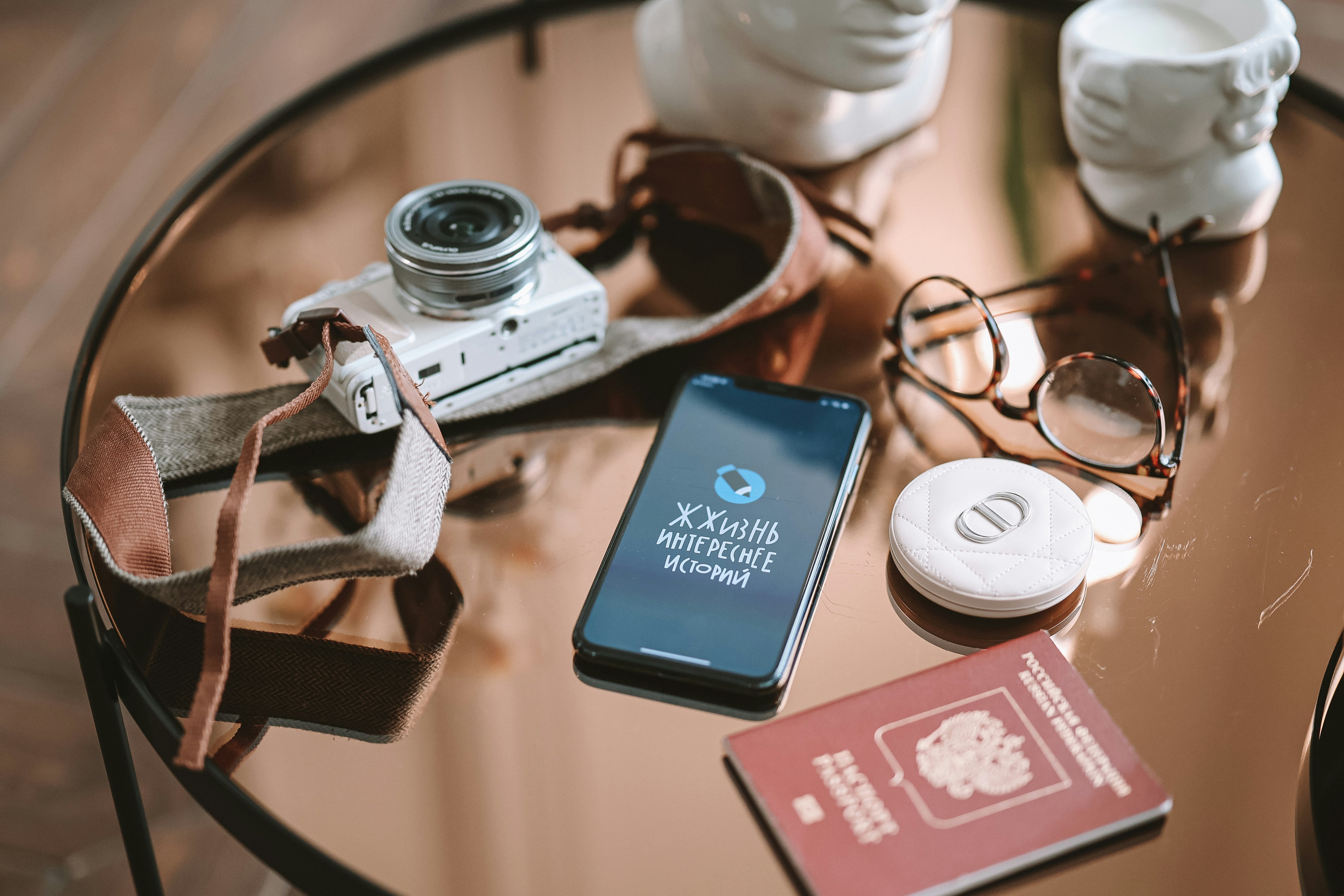 a table topped with a camera and a cell phone, 