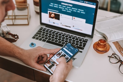 a man sitting at a desk using a cell phone