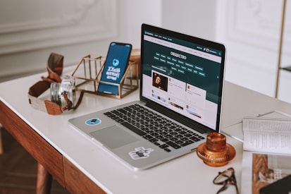 a laptop computer sitting on top of a wooden desk