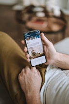 a person holding a cell phone in their hand