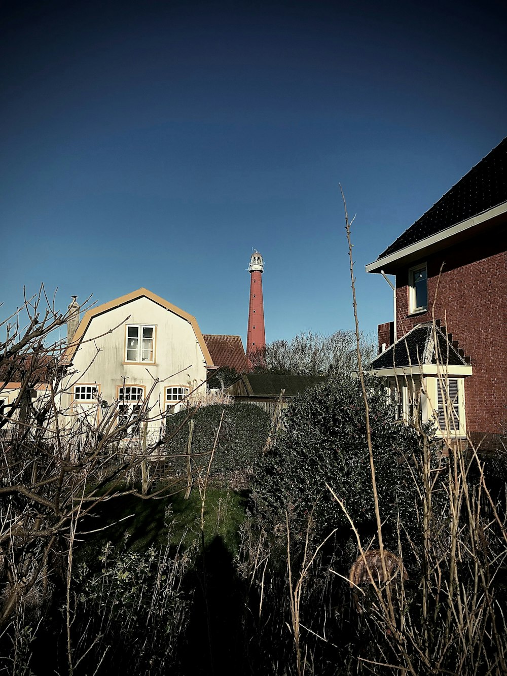 a house with a light house in the background