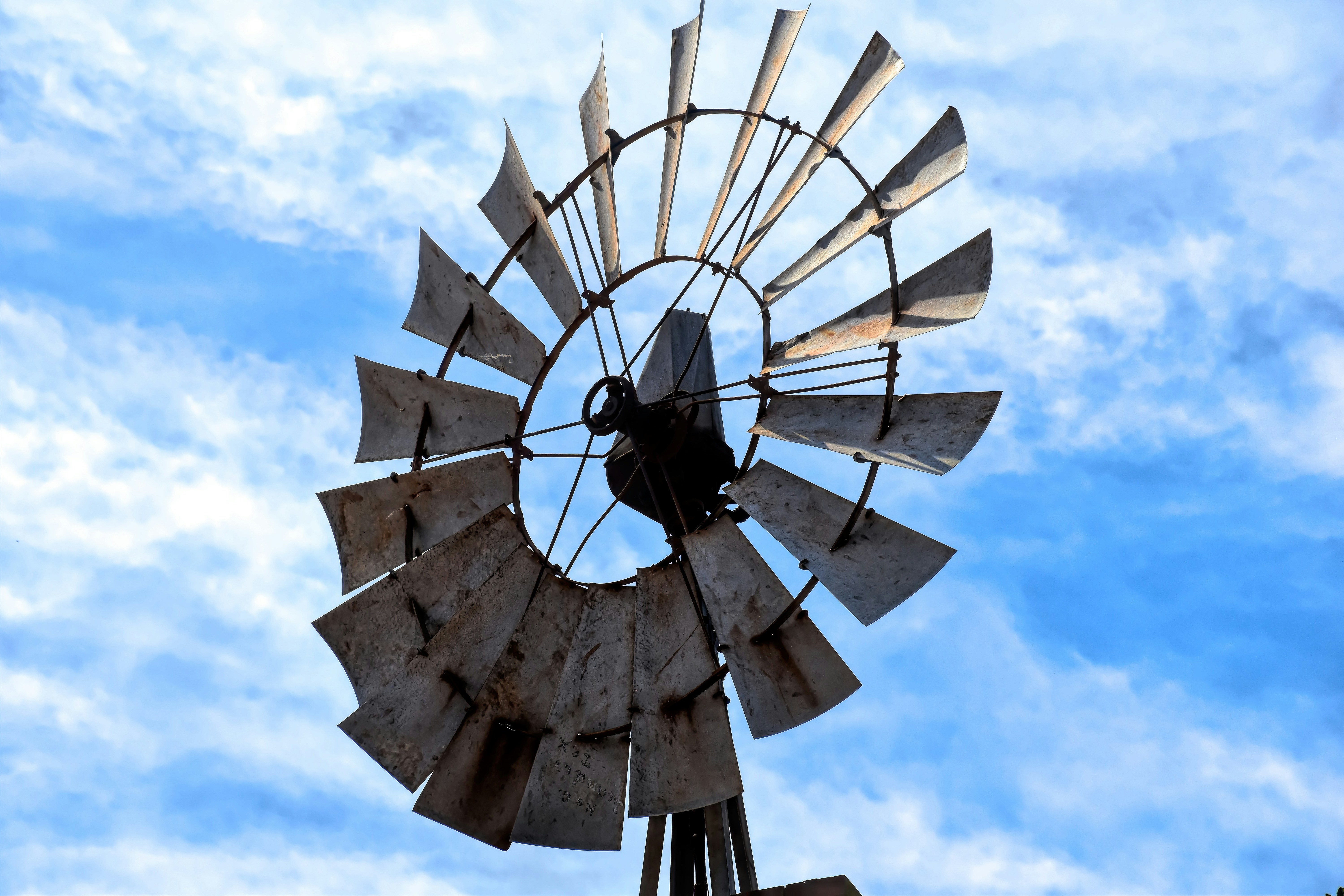 a windmill with a blue sky in the background