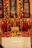 A vibrant church altar decorated with flowers and candles.