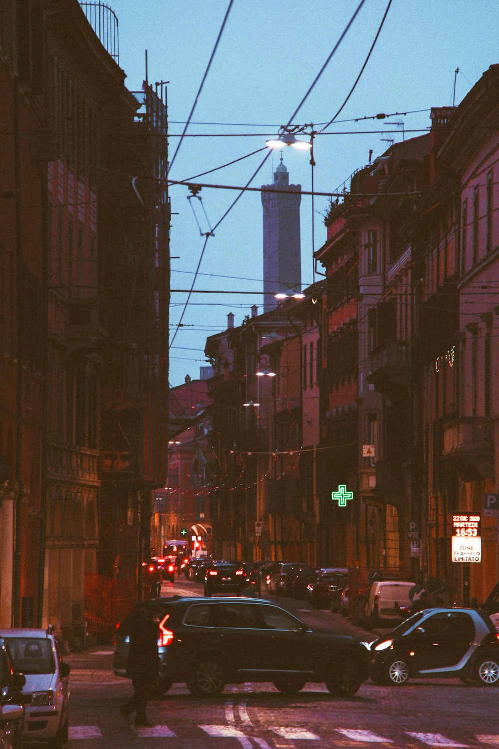 a city street filled with traffic next to tall buildings