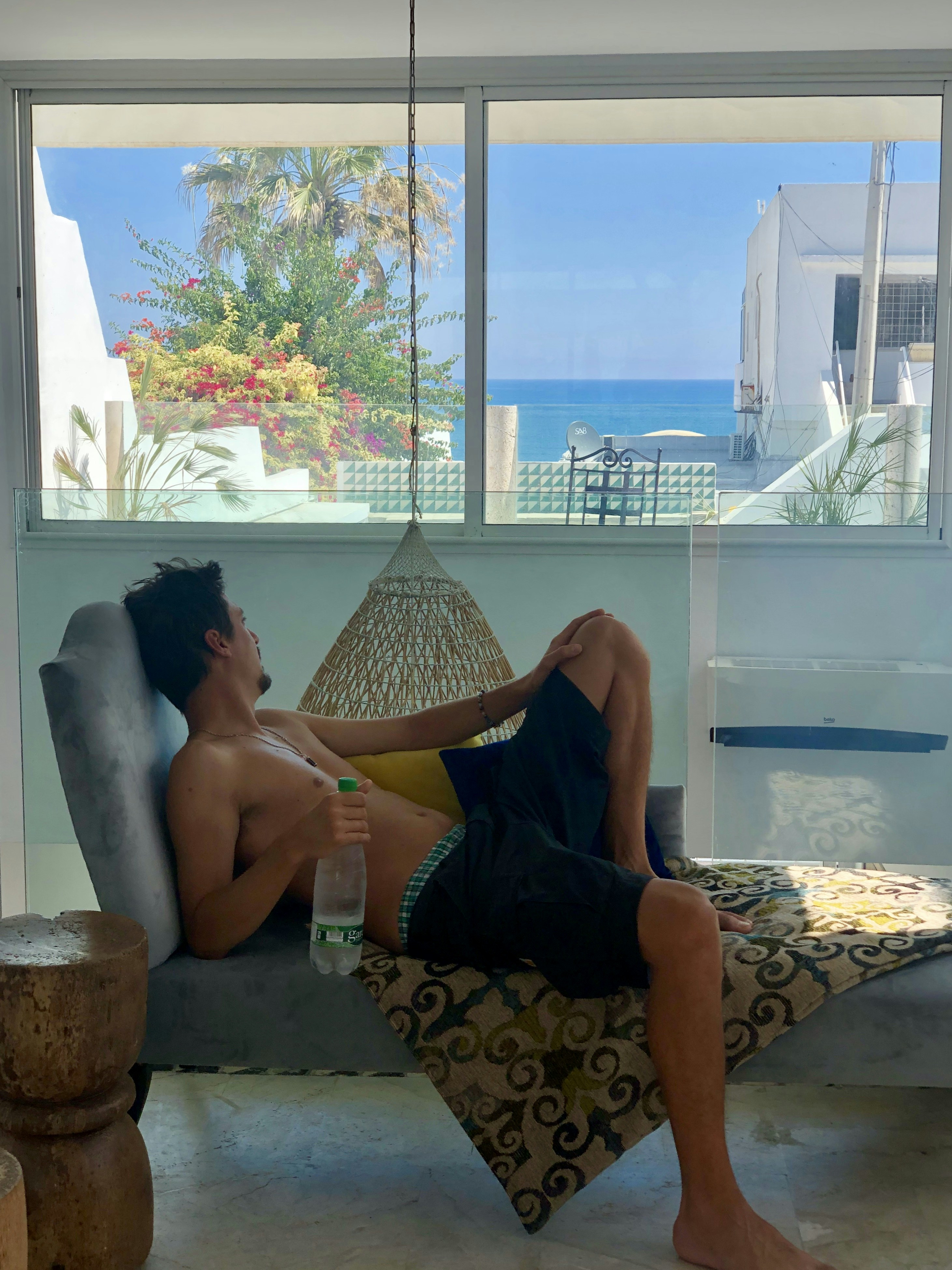 a man sitting in a chair with a drink in his hand