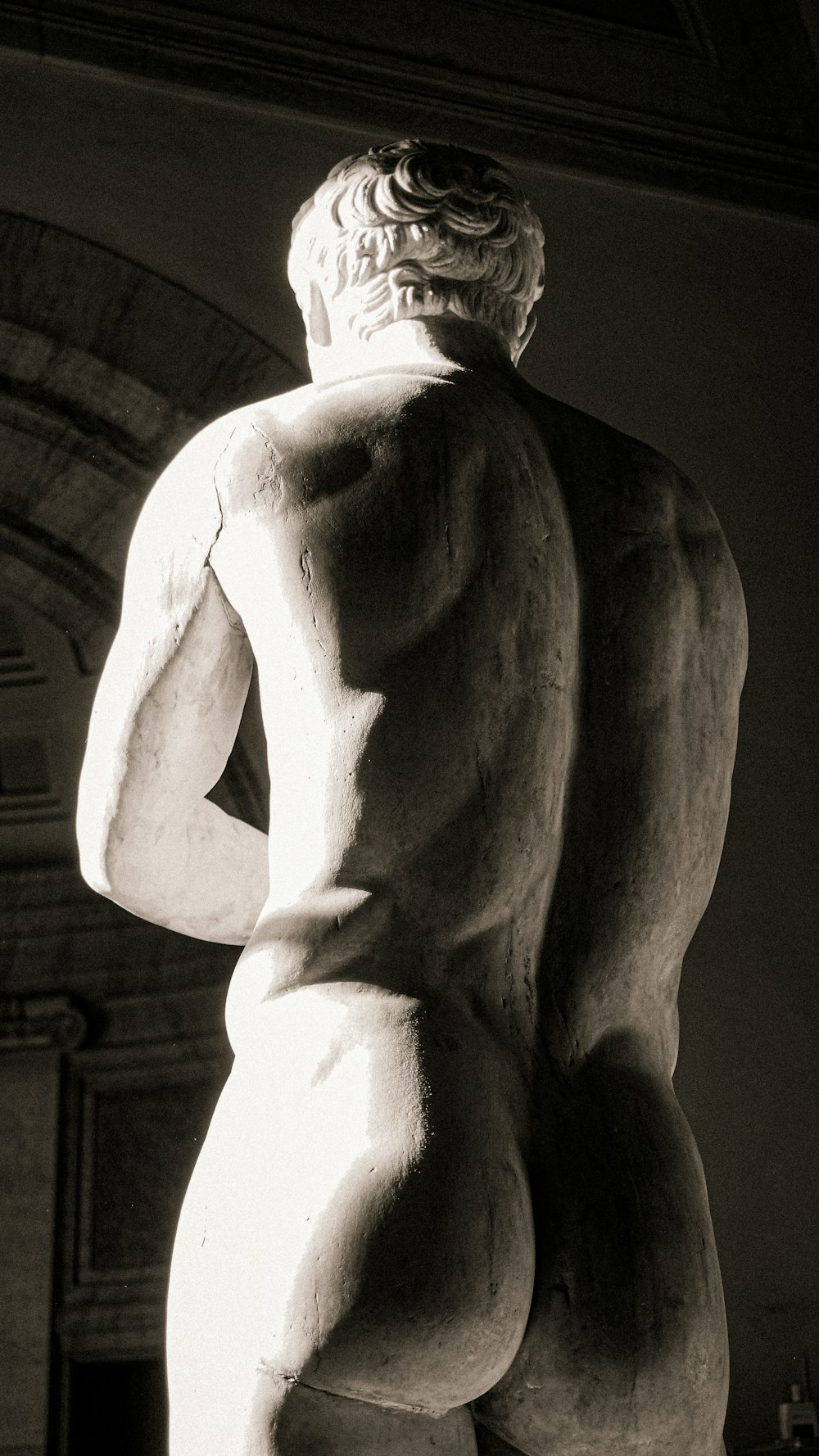 a black and white photo of a statue of a man