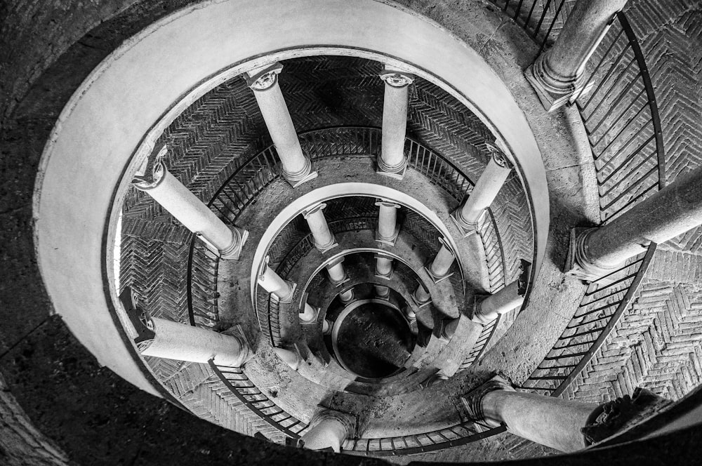 a black and white photo of a spiral staircase