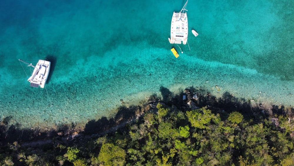 a couple of boats floating on top of a body of water