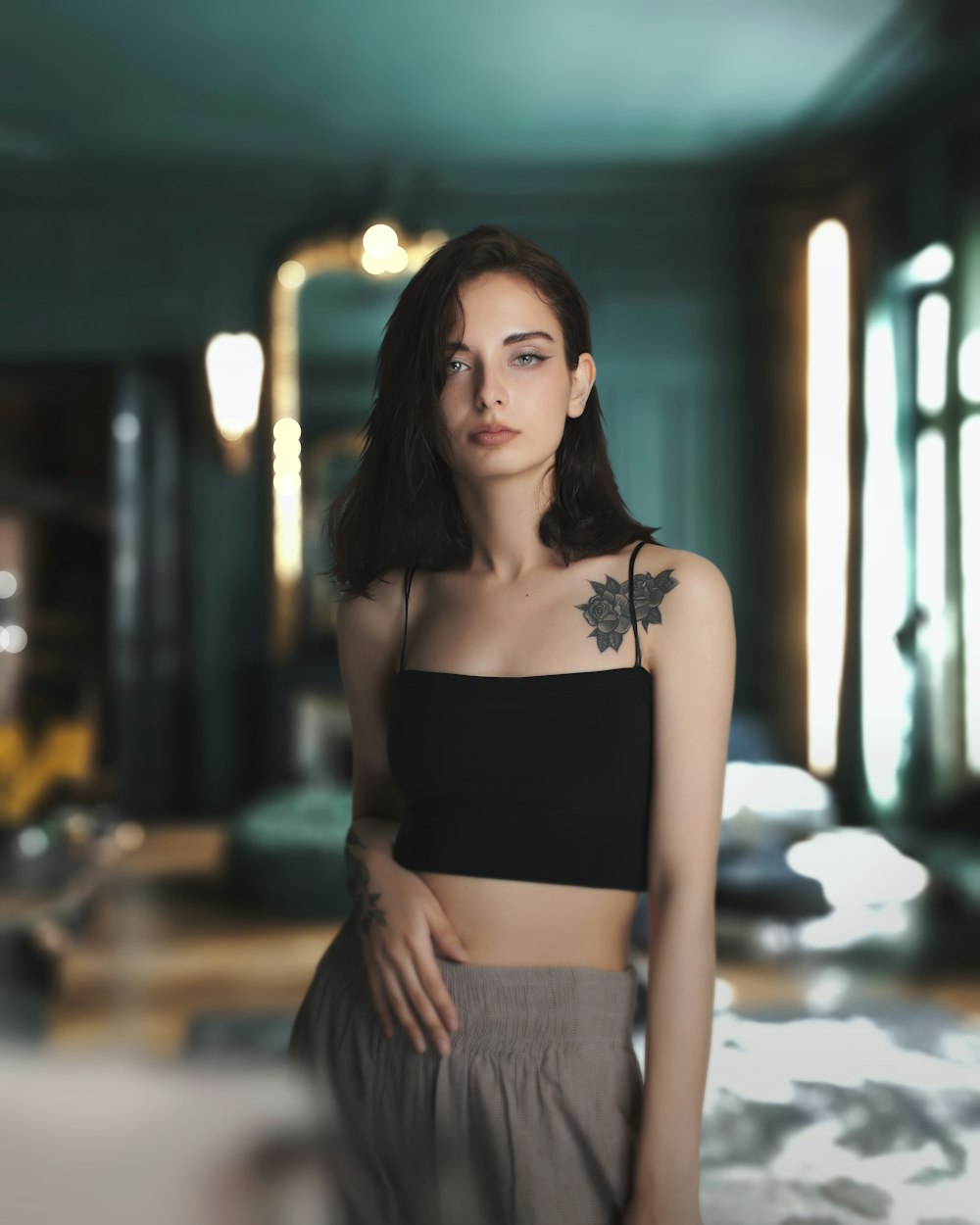 a woman in a black crop top standing in a room