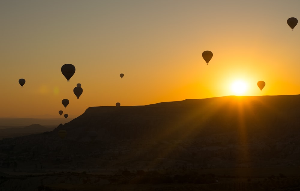 a group of hot air balloons flying in the sky