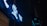 Neon signs with bright, glowing symbols and letters are mounted against a dark background. The signage prominently displays stylized characters in a blue hue, illuminating the surrounding area with their light.